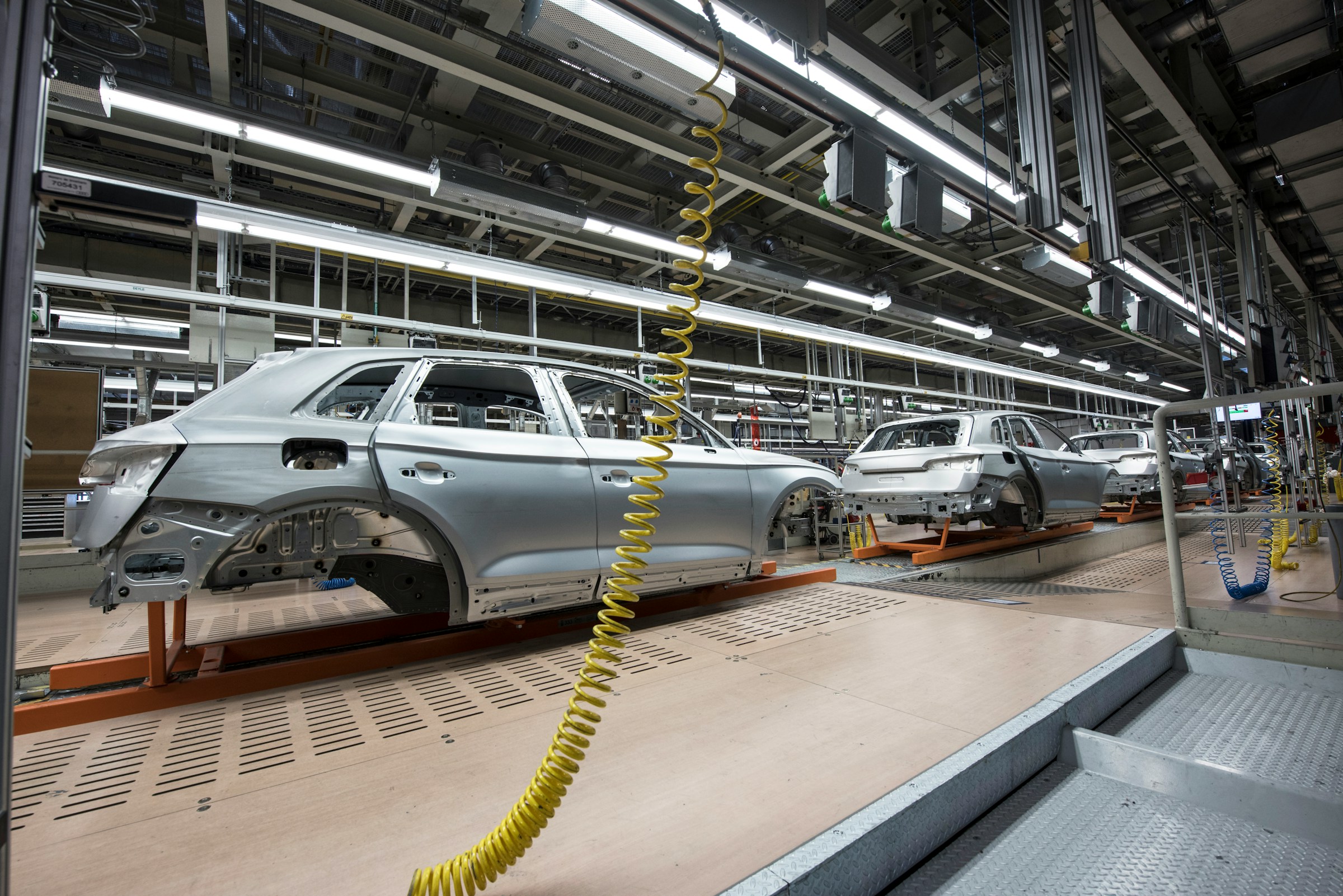 Automotive vehicles being manufactured in the transportation industry.