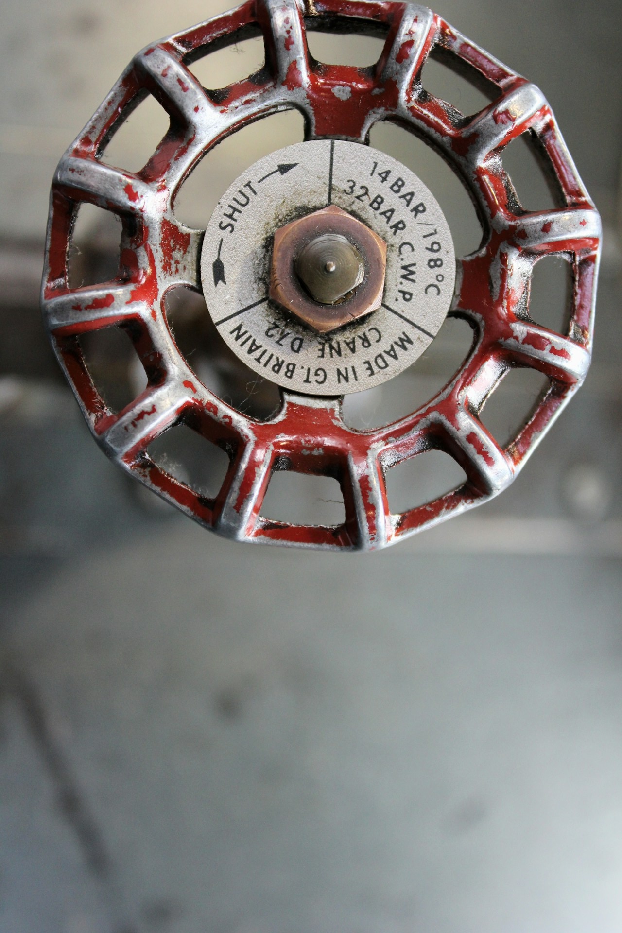 The top of a check valve indicating the direction of flow.